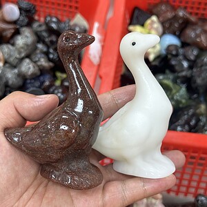 A goose carved from crystal with mixed materials