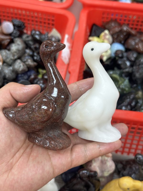 A goose carved from crystal with mixed materials